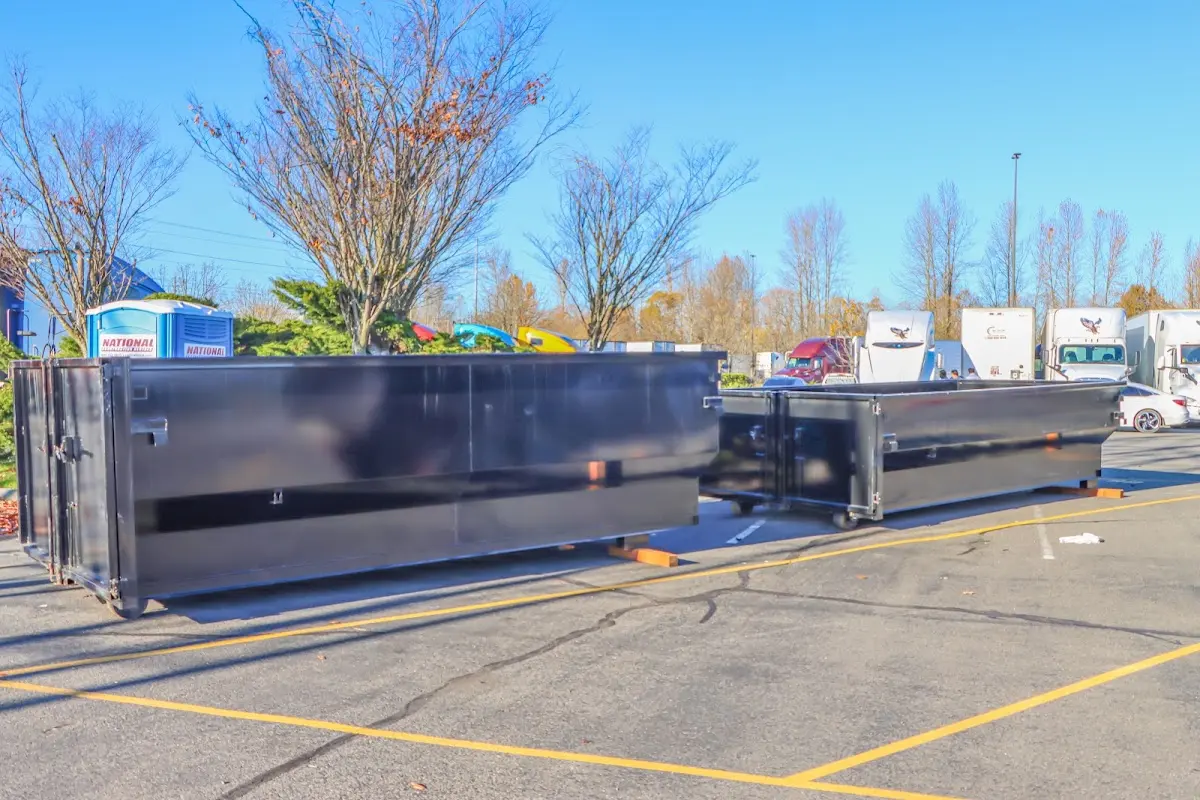 Professional dumpster rental service with roll-off container on residential driveway in Pinehurst